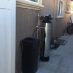 Side view of the praz hard water treatment system in a backyard near the los angeles area