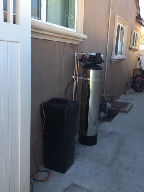 Side view of the praz hard water treatment system in a backyard near the los angeles area