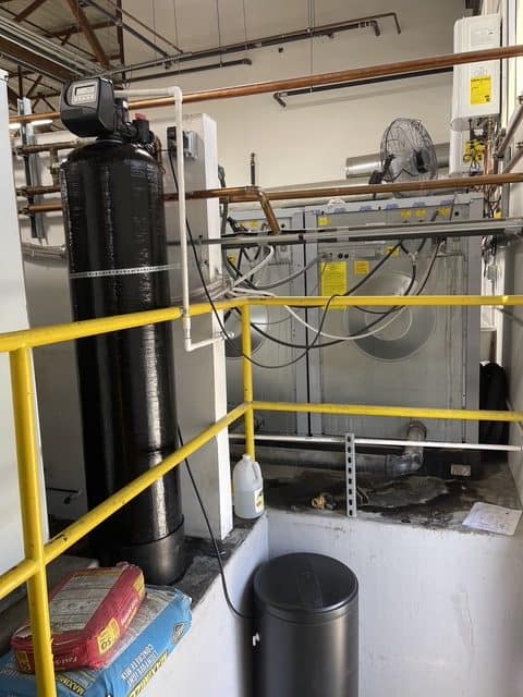 Water softener installed alongside commercial laundry equipment in Los Angeles