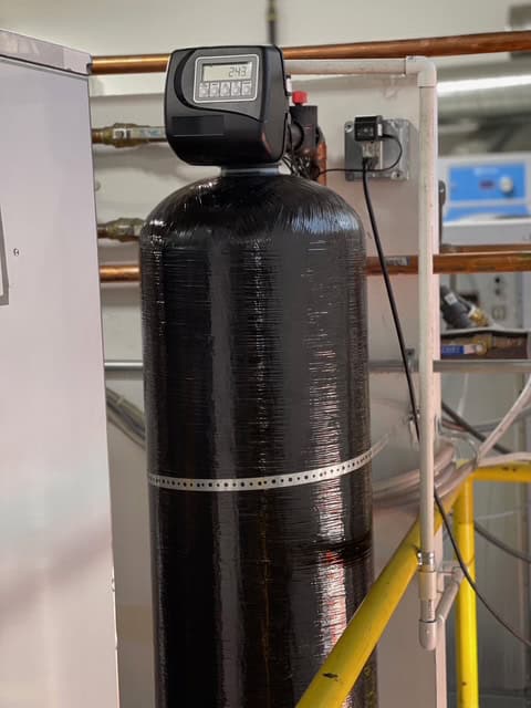 Commercial water softener tank with digital control valve installed in a Los Angeles facility
