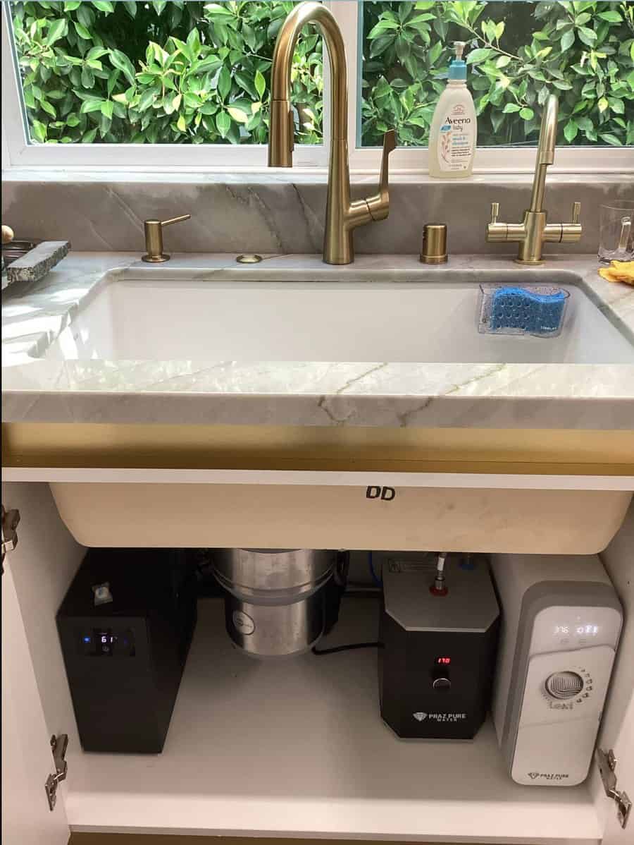 Kitchen with gold filtered water faucets and a drinking water system, instant hot water and chiller under the sink