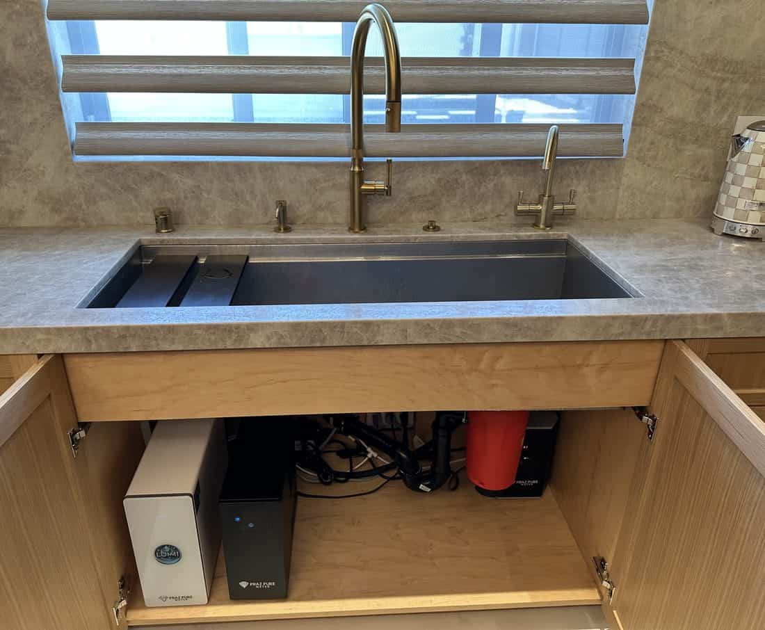 Lumi drinking water package with instant hot water and chiller installed under a kitchen sink, leaving free cabinet space