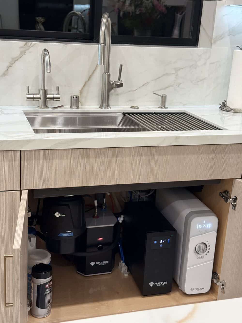 Water filtration system installed in a marble kitchen with instant hot water, chiller and filtered water faucet